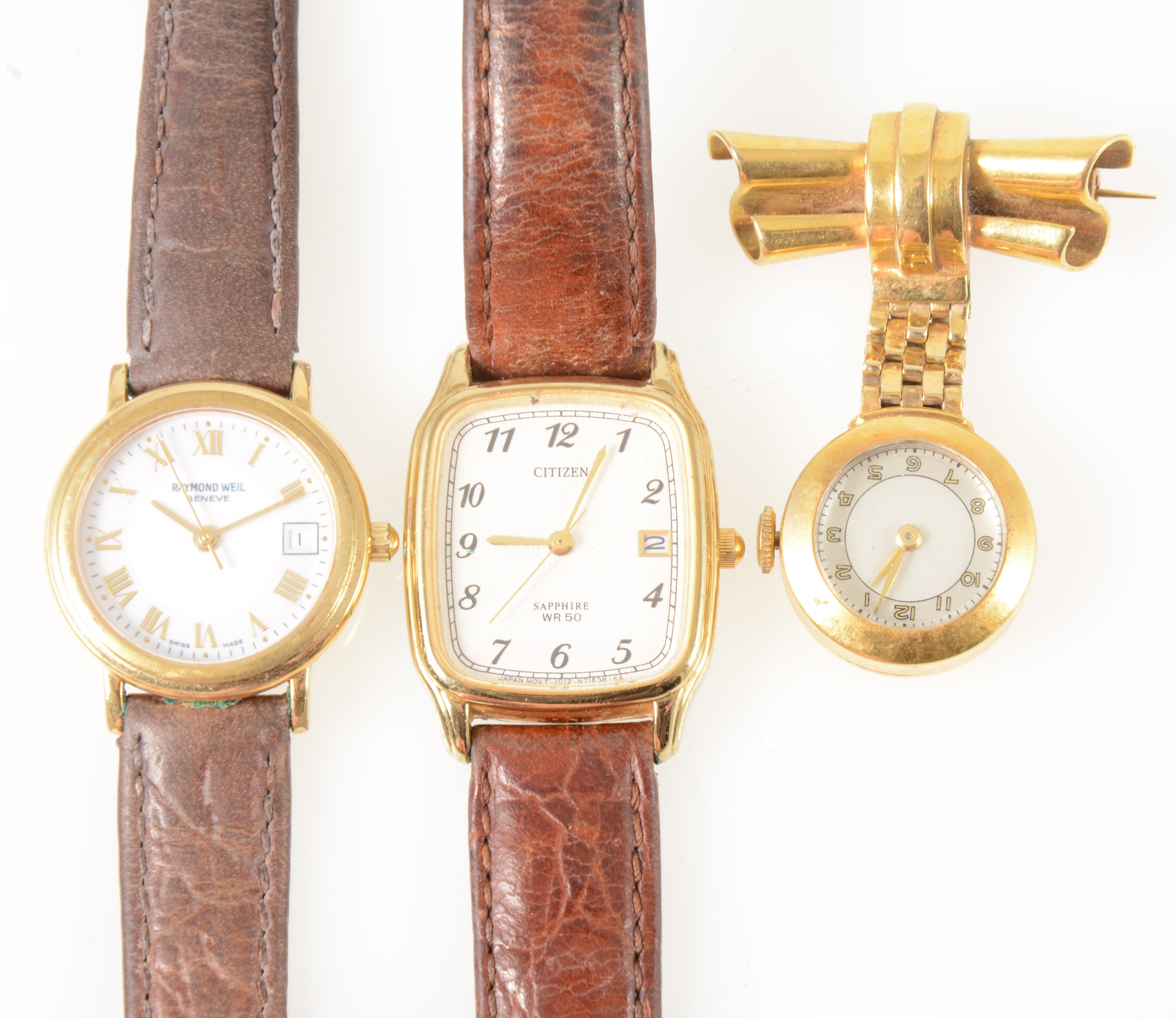 A yellow metal lapel watch and two gold-plated wrist watches.