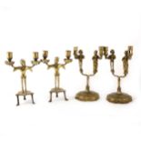 Two pairs of cast brass Neo-Gothic style figural twin-light candlestands