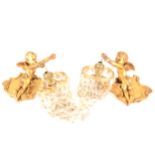 A pair of modern gilded cherub wall lights with glass lustres.