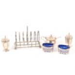 A six section silver toast rack, and other silver cruets and pepperettes