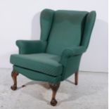 A reproduction wing-back easychair