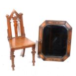 A Victorian oak hall chair in the Gothic style, and an oak framed mirror