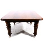 A Victorian oak extending dining table