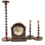 An oak cased mantel clock, pair of oak barleytwist candlesticks, and a smoker's companion