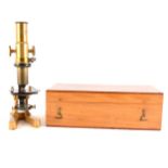 A lacquered brass gilt metal monocular microscope