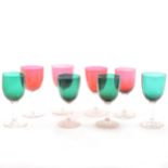 A collection of glassware including green and ruby coloured stemware