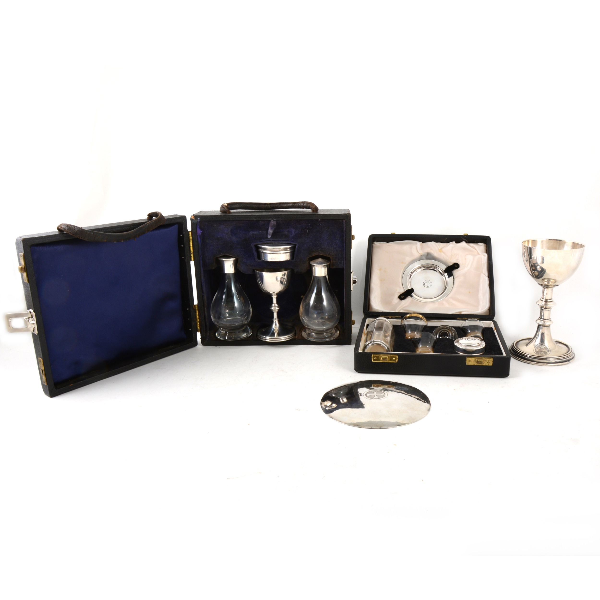 Two travelling communion sets, one silver, the other plated, and another paten and chalice.
