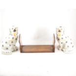 A pair of Staffordshire seated King Charles Spaniels, and a Sorrento ware book rack