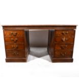 An Edwardian oak twin pedestal desk