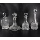 Five glass decanters, including Waterfords Crystal ships decanter, another Waterfords Crystal