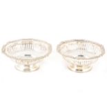 A pair of silver circular bonbon dishes.