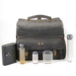Leather travelling bag with part fitted silver-mounted glass bottle set,