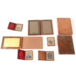 Four ambrotype photographs, each cased, and four folding leather photograph sleeves