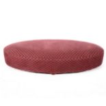 An oval upholstered foot stool
