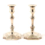 A pair of Georgian style silver candlesticks, Harrods, Birmingham 1965