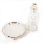 A silver salver and pinched glass decanter with silver collar.
