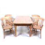 A modern pine kitchen table and four beechwood elbow chairs