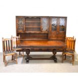 A reproduction stained oak dining room suite