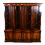 A reproduction mahogany breakfront bookcase, George III style