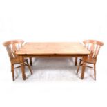 A pine kitchen table and four chairs