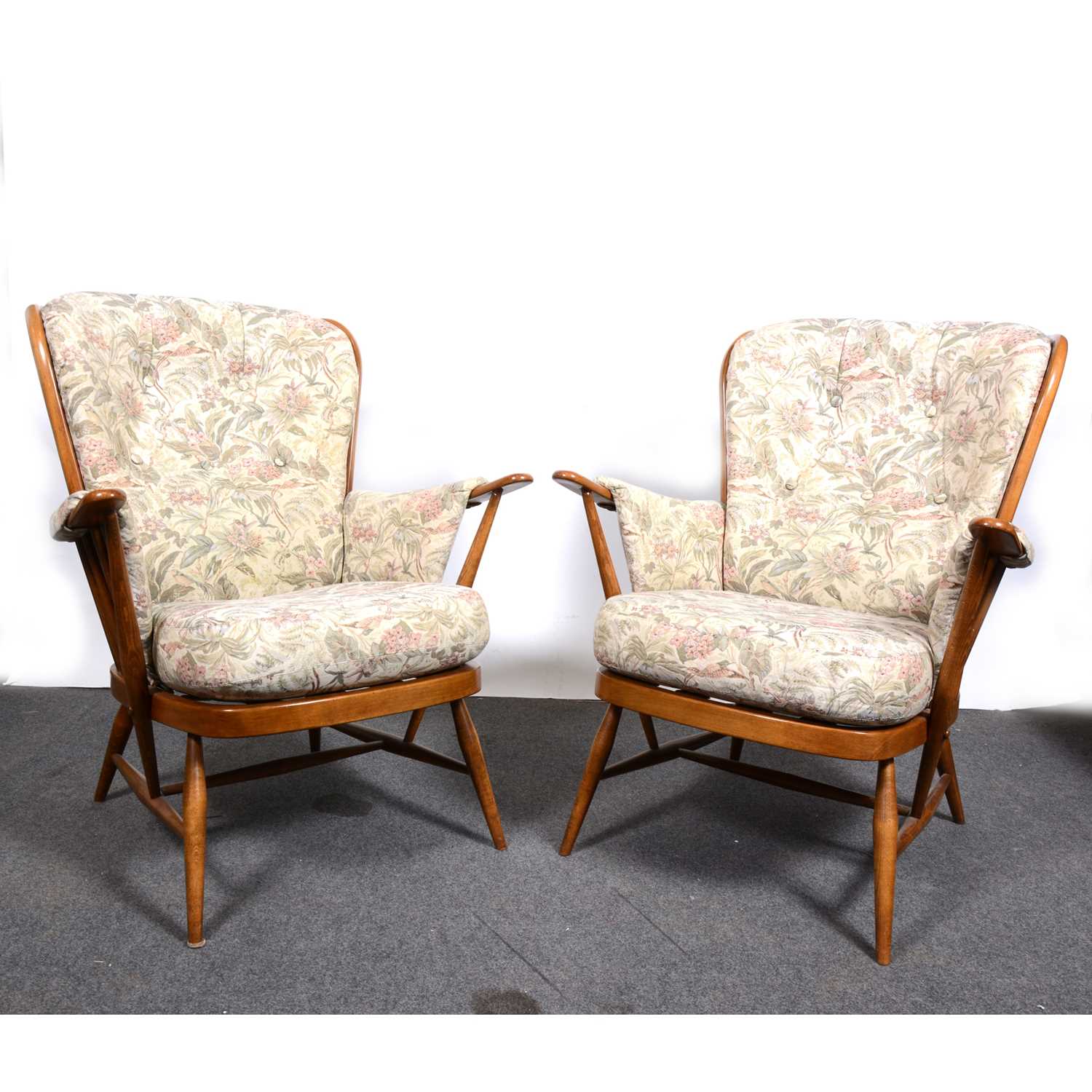 A pair of Ercol elbow chairs