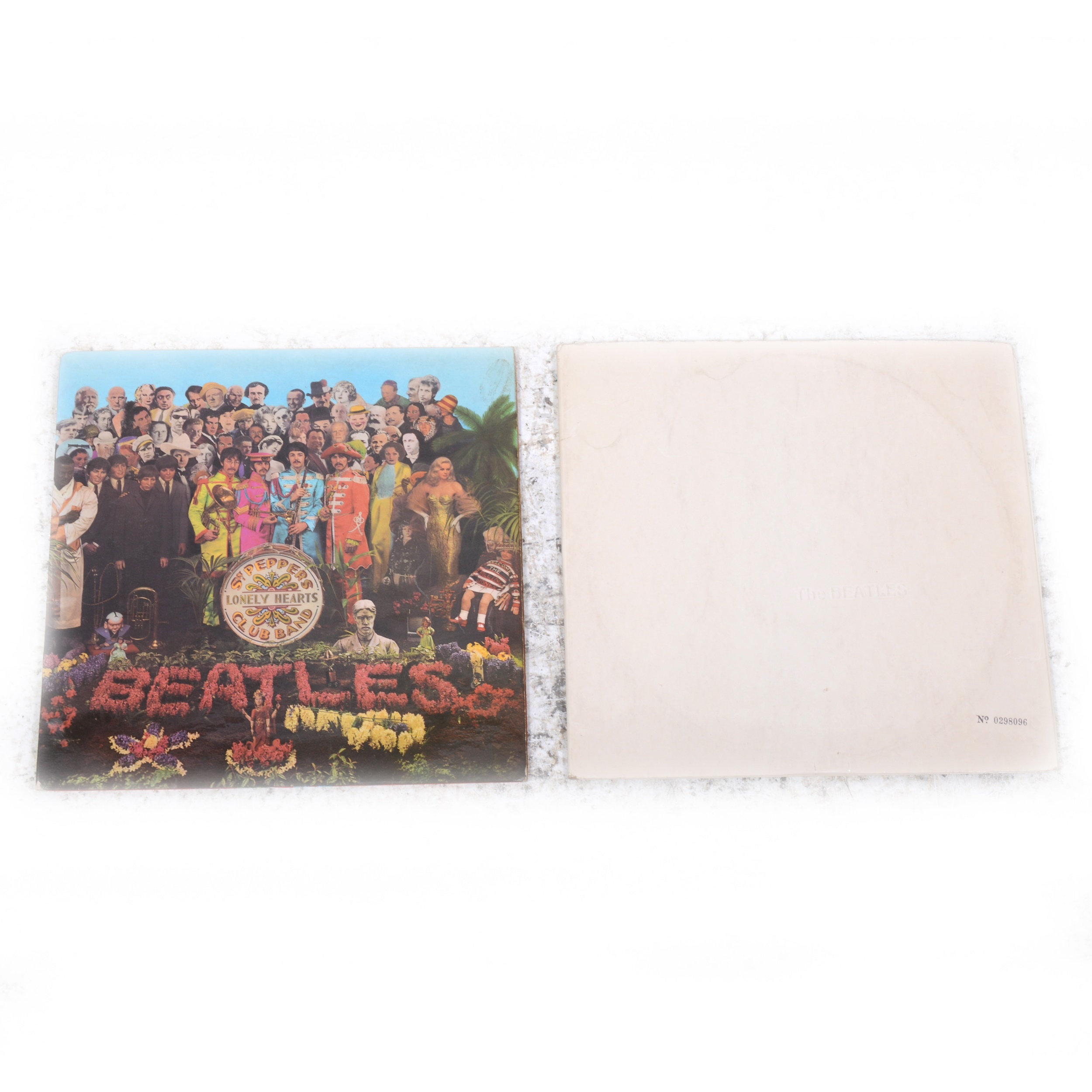 The Beatles White Album and Sgt. Pepper's Loney Hearts Club Band vinyl LP records.