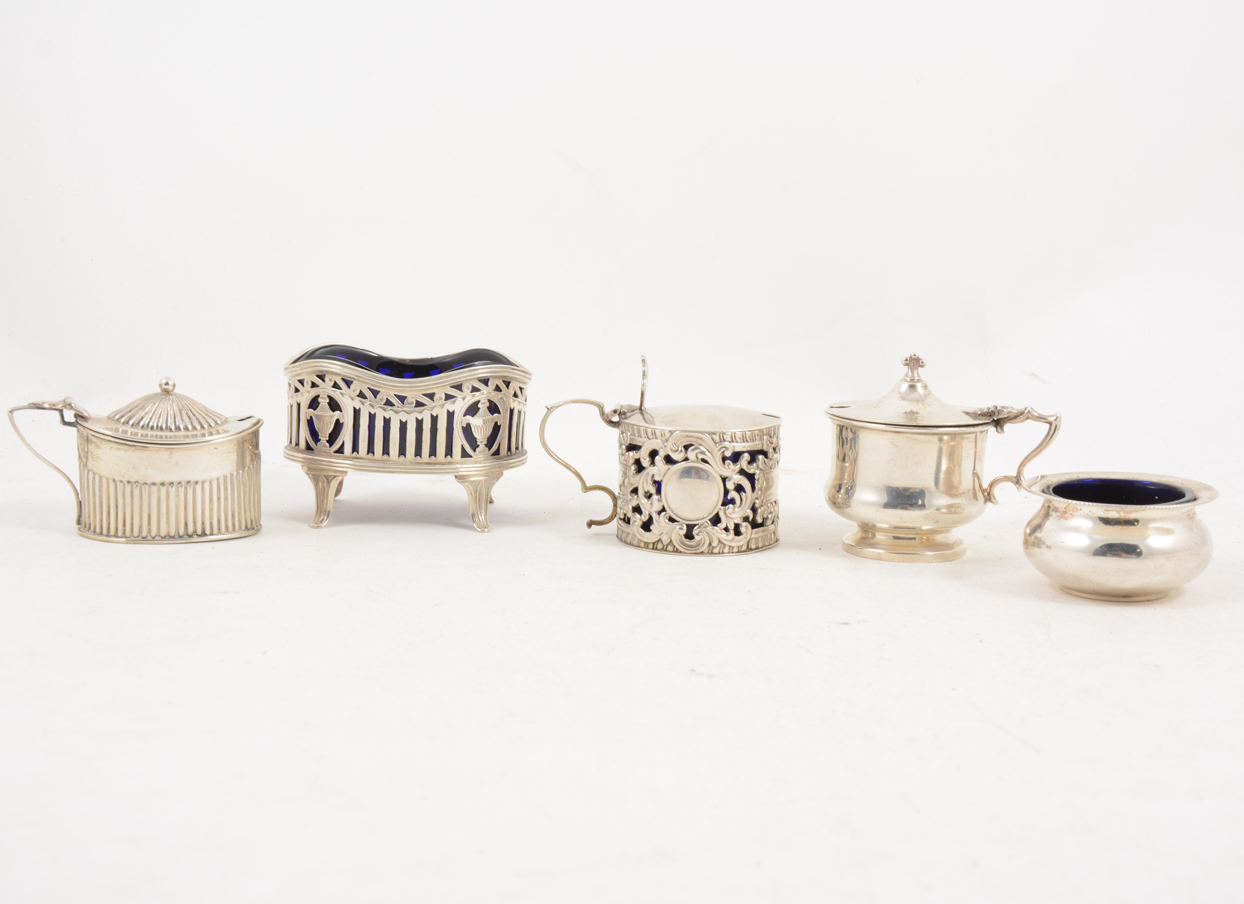 Three silver mustard pots and two salts,