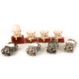 Three novelty porcelain Humpty Dumpty egg cups, and four silver plated Noddy Car egg cups