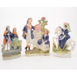 Fourteen Staffordshire figures and spill vases