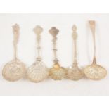 Five large ornate silver sugar sifting spoons.