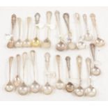 Nineteen decorative silver and white metal salt spoons.