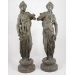 Pair of spelter patinated figures of muses, standing in diaphanous robes, holding a lyre, pipe and