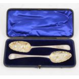 A cased set of George III silver berry spoons with later engraving.