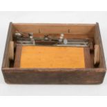 A braille typewriter, in a pine box, 38cm.