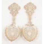 A pair of silver spoons with pierced bowls by Goldsmiths & Silversmiths Co Ltd.