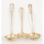 Three silver sugar sifting spoons with gilded berry bowls.