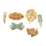 A collection of vintage enamel dress clips and brooches.