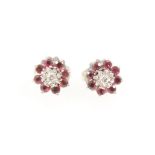 A pair of ruby and diamond ear studs.