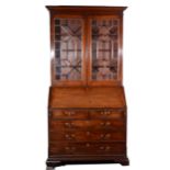 George III mahogany bureau with a matched bookcase top,