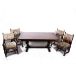 A reproduction stained oak dining room table and six chairs