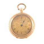 A small yellow metal open face pocket watch