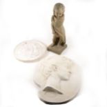 Two plaster wall plaques and a plaster figure of child.