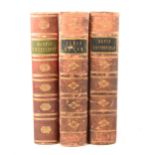 Three early leather bound Charles Dickens books.