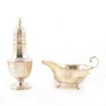 A silver caster and silver sauce boat.