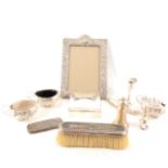 A selection of silver items, to include silver condiments, photograph frame, cigarette box, etc.