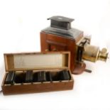 A mahogany and gilt metal magic lantern, and a large collection of lantern slides