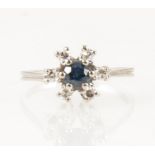 A sapphire and diamond circular cluster ring.