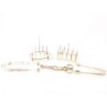A small quantity of silver and white metal items, including toast racks and sugar tongs.