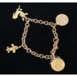 A 9 carat yellow gold bracelet with three charms and a Half Sovereign