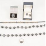 A collection of haematite jewellery, two necklaces, two rings, earrings and silver earrings.